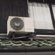 How to Save Money on Your Energy Bills with HVAC Upgrades An HVAC unit on a roof that could use an upgrade to save money on energy bills.