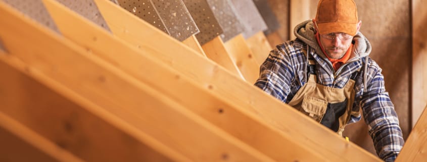 HVAC Specialist working in attic area on ducts