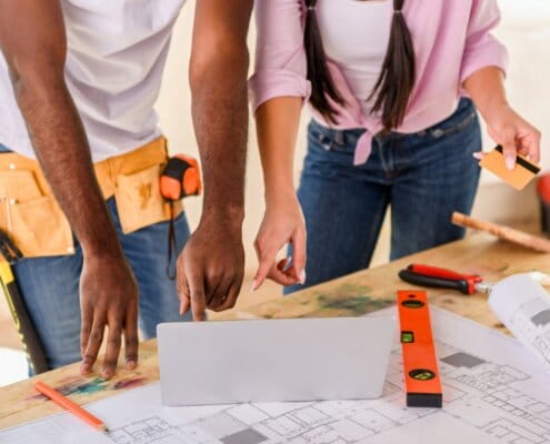 cropped shot of couple using laptop while making renovation of home