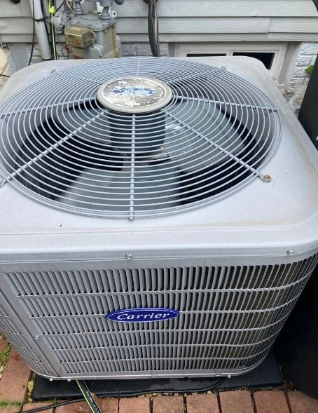 Carrier outdoor AC unit inspected during an air conditioning repair by Briggs Heating & Air Conditioning in Leesburg, VA